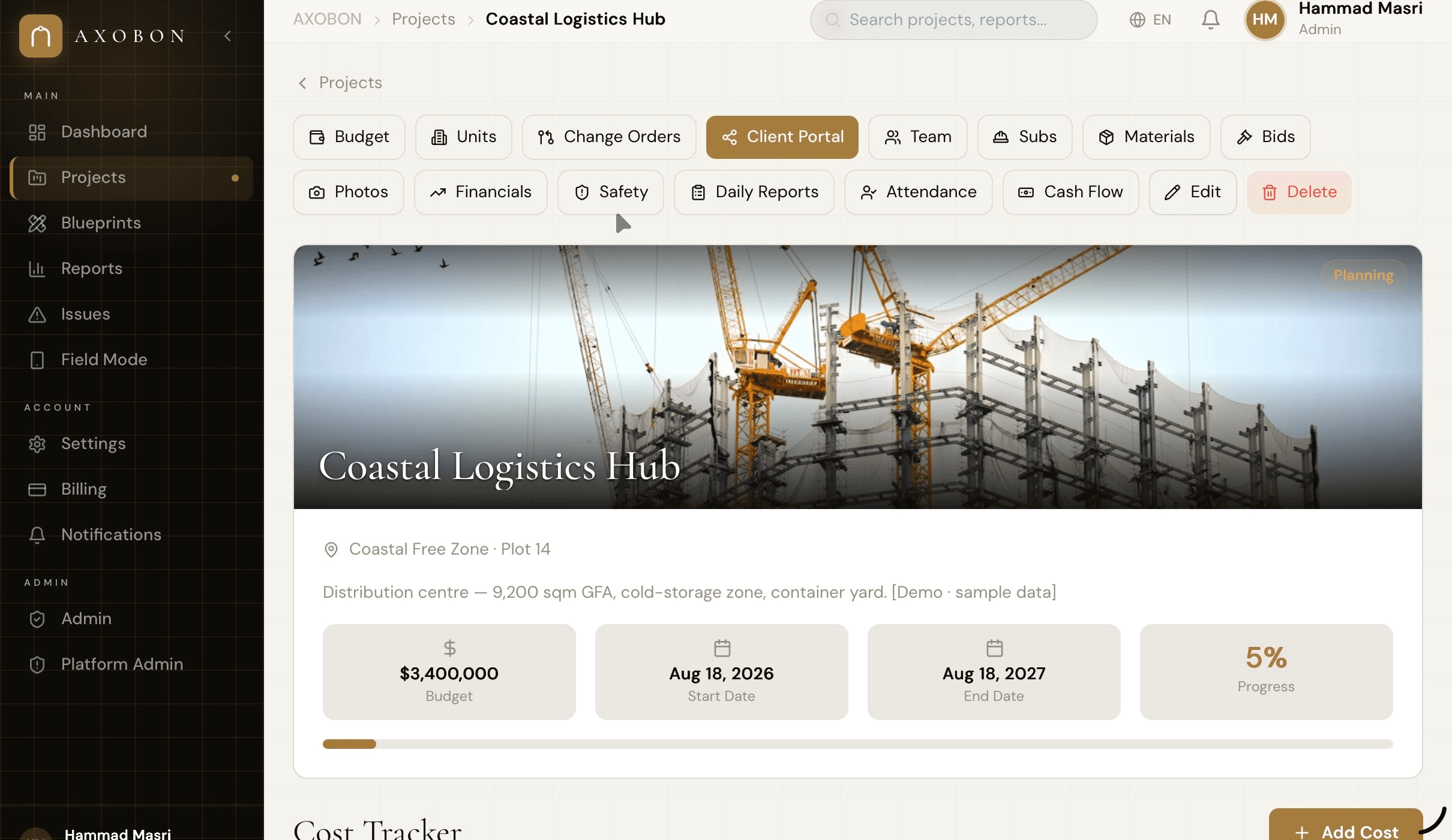 AXOBON project detail — tab bar shows Budget, Units, Change Orders, Client Portal, Team, Subs, Materials, Bids, Photos, Financials, Safety, Daily Reports, Attendance, Cash Flow